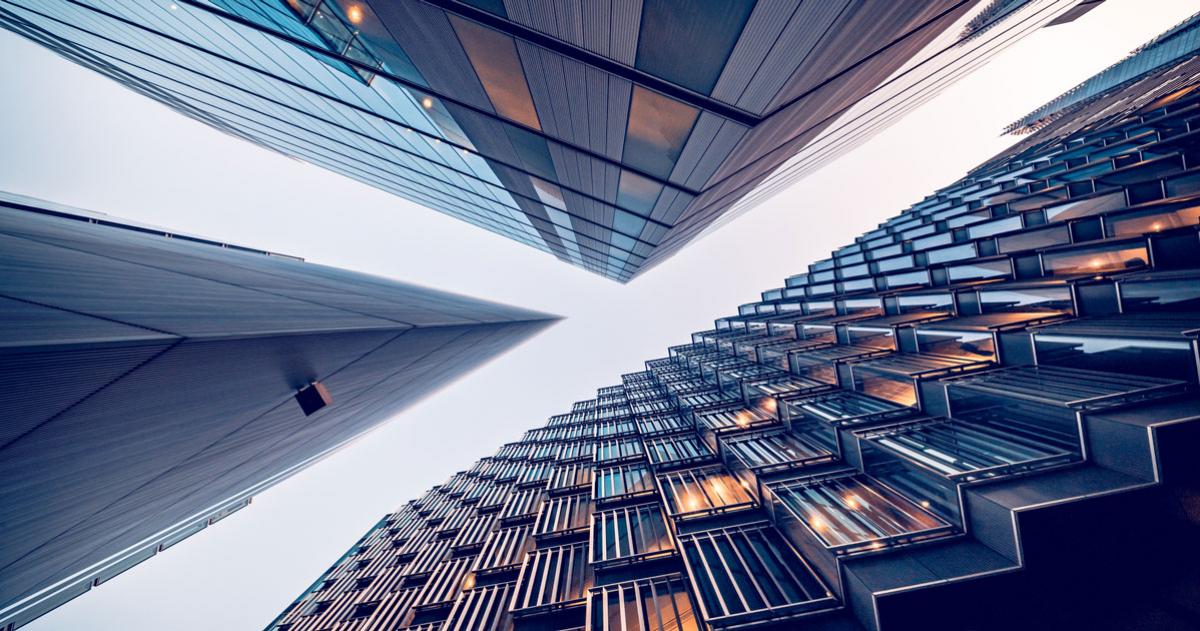 Looking up at three skyscraper looking buildings