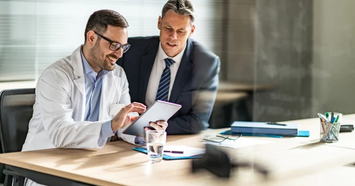 Physician reviewing content with a financial advisor