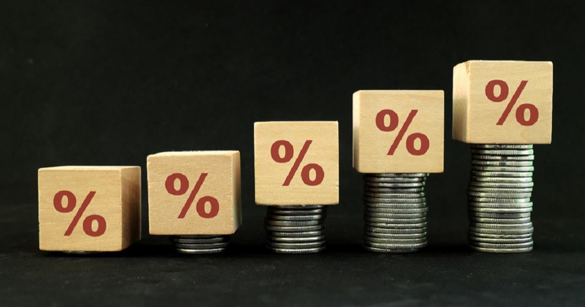 Image of wooden blocks with a percent type stacked on coins that increase
