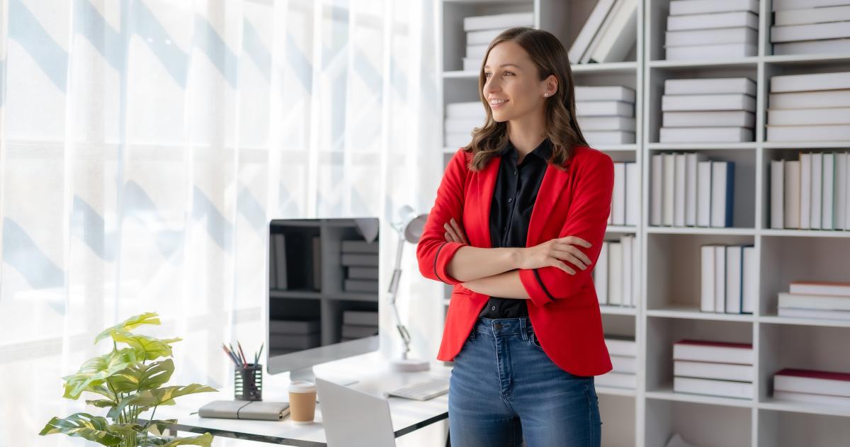 Woman standing at desk looking confident