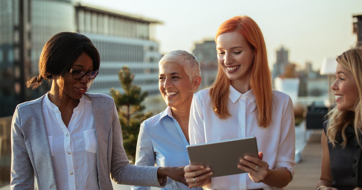 Group of women looking at a tablet