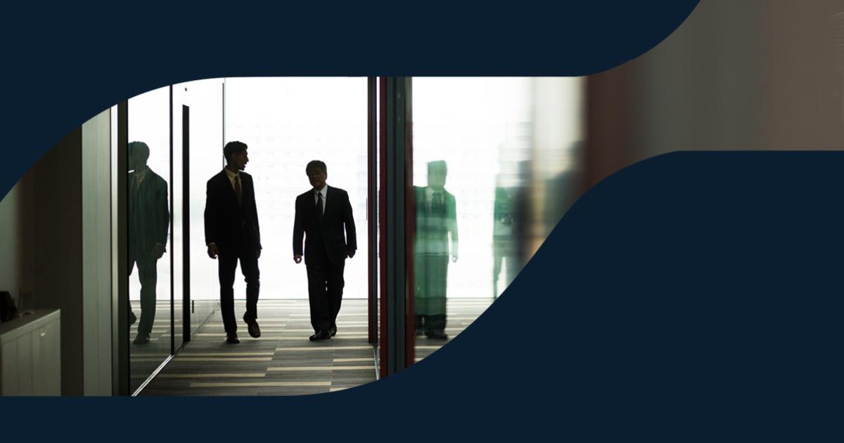 An advisor and client walking down a hallway