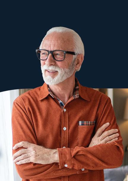 An older gentemand with his arms crossed looking to the right