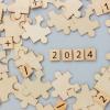 Puzzle pieces and tiles spelling out the year 2024