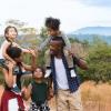 Parents with three kids on a hike with nature in the background