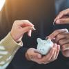 Piggy bank with three hands putting coins in