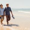 Retired couple walking on beach