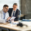 Physician reviewing content with a financial advisor
