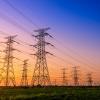 Image of power lines with a sunset in the background