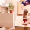 Person taping moving boxes closed