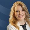 Headshot of Frances Cronlund over a blue Curi RMB Capital themed background