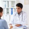 Young physician listening to a patient