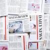 Newspapers spread across table