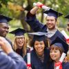 Group of college graduates in caps and gowns having their picture taken