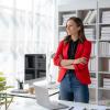 Woman standing at desk looking confident