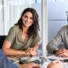 Woman and man sitting at conference table talking to an advisor