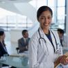 Young female physician in a hospital smiling at camera