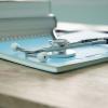 Desk with a notebook and stethoscope on it
