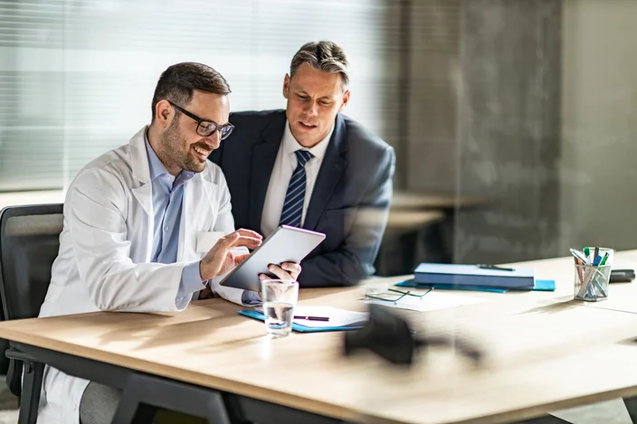 Physician reviewing content with a financial advisor