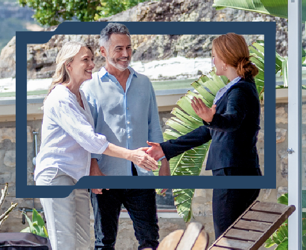A smiling couple, the woman shaking hands with another woman in a suit