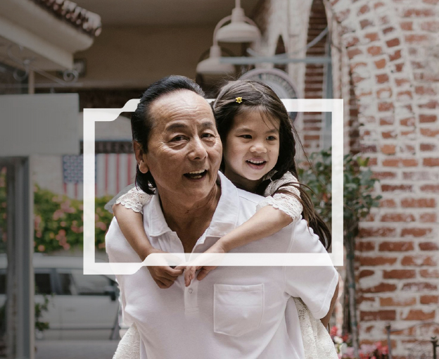 A dad carrying his daughter